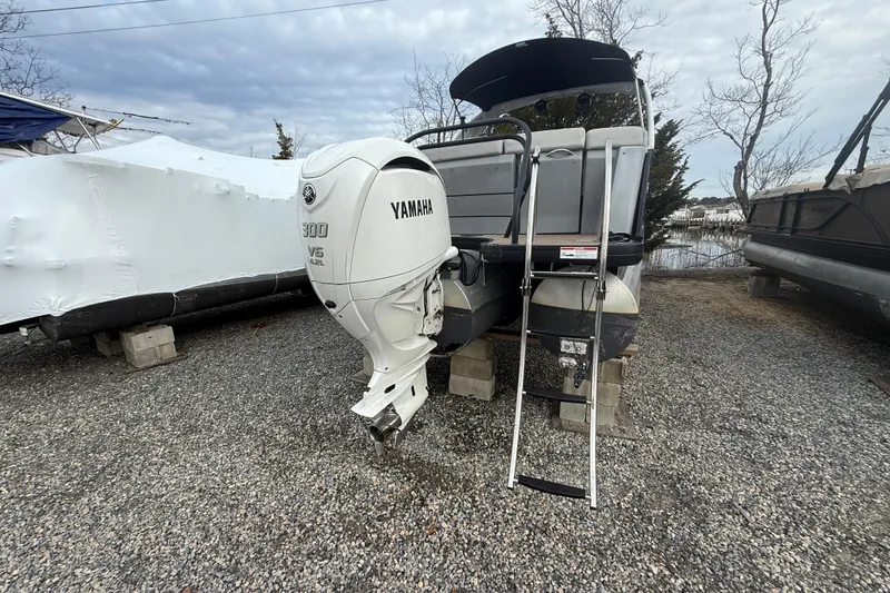 Slide: The Image of 2023 Godfrey AquaPatio 255 ULC with Yamaha 300 V6 outboard engine on gravel. - 4