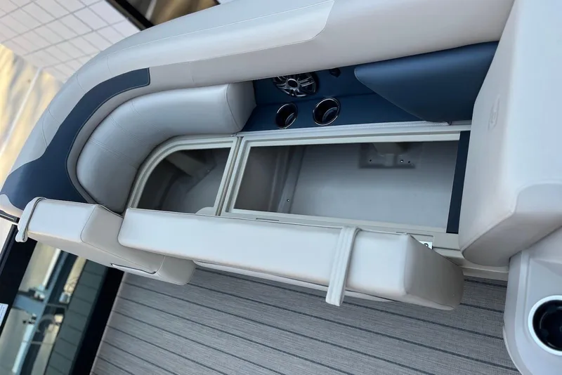 Slide: The Image of 2026 Godfrey SWEETWATER 2286 SFL boat interior with storage compartment and seating. - 11