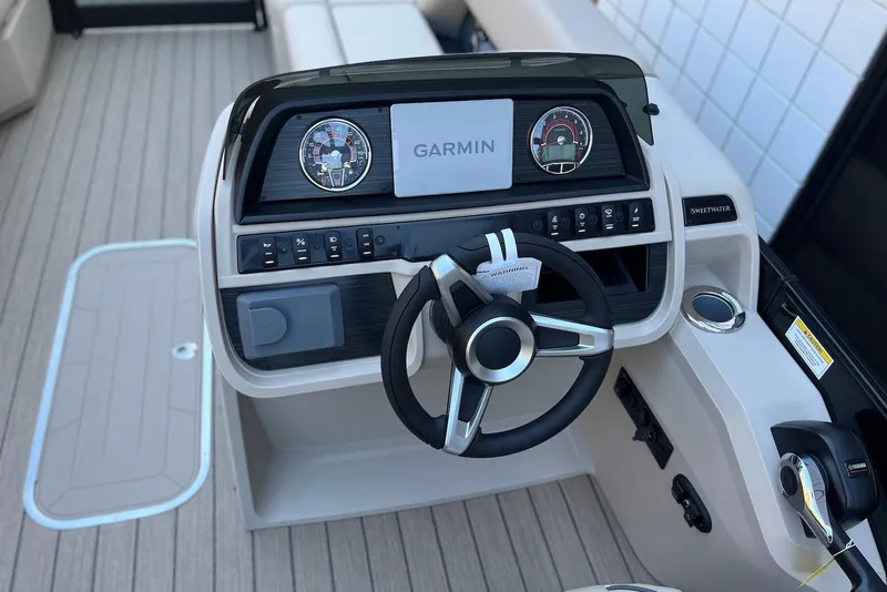 Slide: The Image of 2026 Godfrey SWEETWATER 2286 SFL boat dashboard with Garmin display and steering wheel. - 14