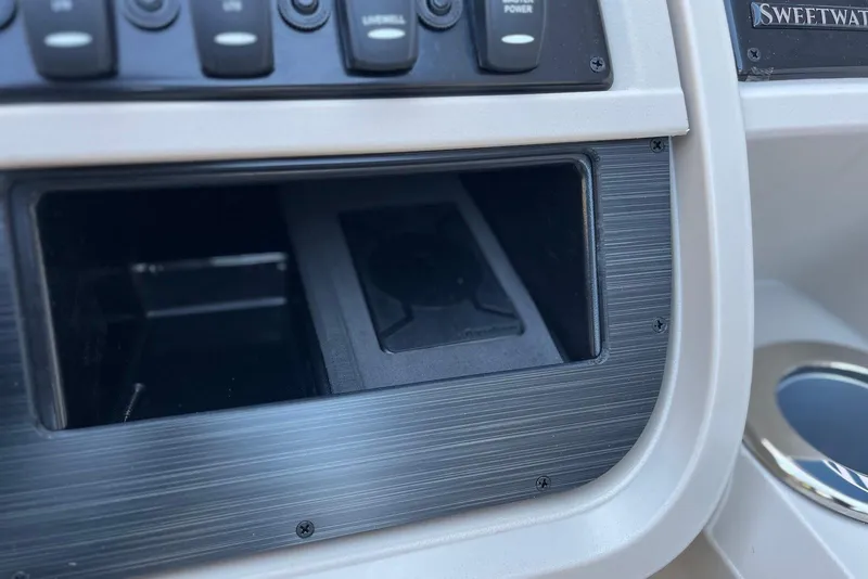 Slide: The Image of Control panel of 2026 Godfrey SWEETWATER 2286 SFL boat with switches and storage compartment. - 15