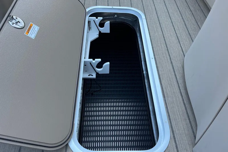 Slide: The Image of Open storage compartment on 2026 Godfrey SWEETWATER 2286 SFL boat deck. - 17