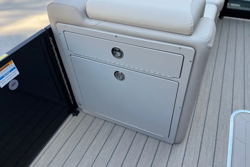 Slide: The Image of 2026 Godfrey SWEETWATER 2286 SFL boat interior storage compartment with cushioned seating. - 18