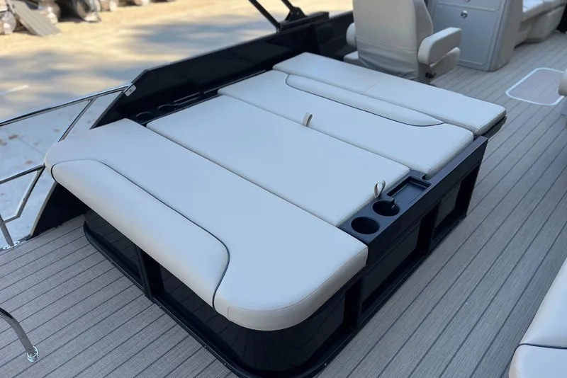 Slide: The Image of 2026 Godfrey SWEETWATER 2286 SFL boat with beige seating and cup holders. - 26