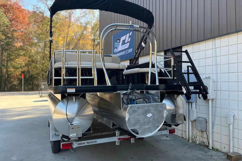 Slide: The Image of 2026 Godfrey SWEETWATER 2286 SFL pontoon boat on trailer, parked outdoors. - 3