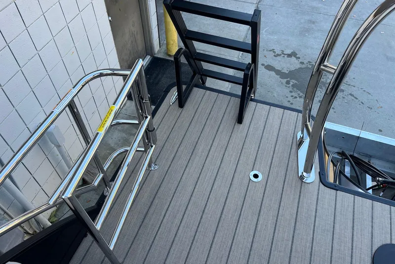 Slide: The Image of Deck of 2026 Godfrey SWEETWATER 2286 SFL with stainless steel railings and ladder. - 30