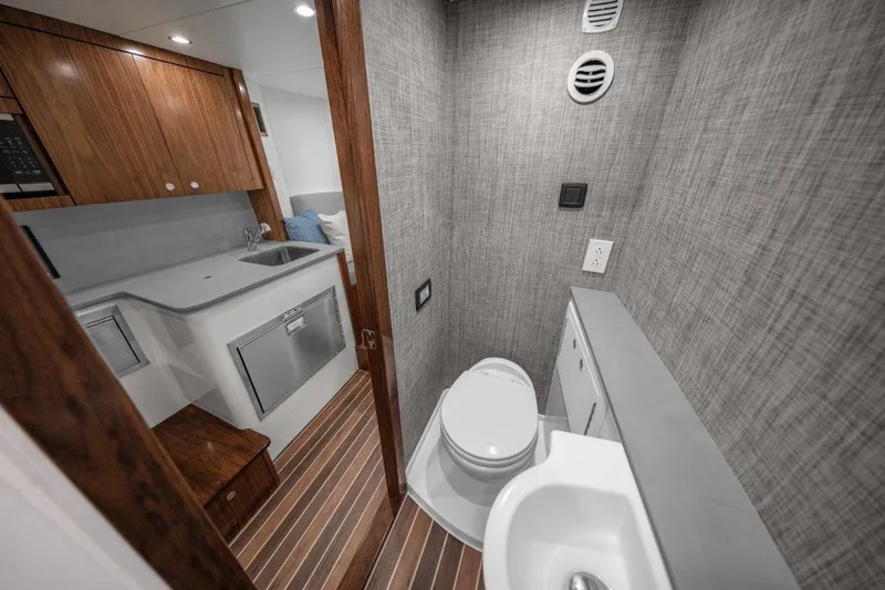 Slide: The Image of Modern bathroom and kitchenette in 2026 Albemarle 45 Carolinian yacht, featuring sleek design and wood accents. - 13