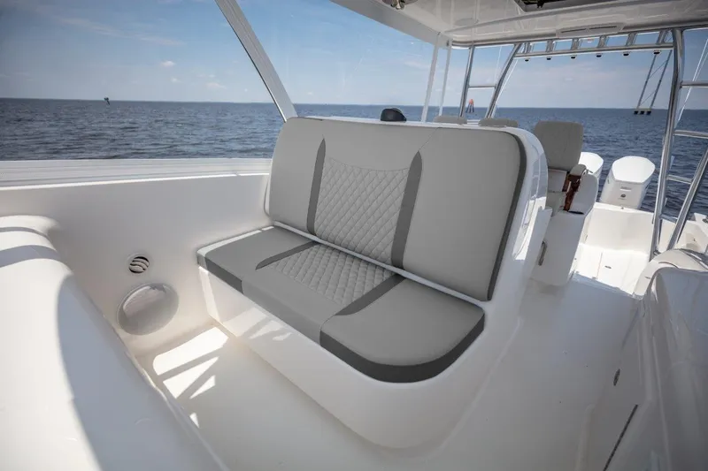 Slide: The Image of 2026 Albemarle 45 Carolinian boat interior with gray seating, ocean view in background. - 16