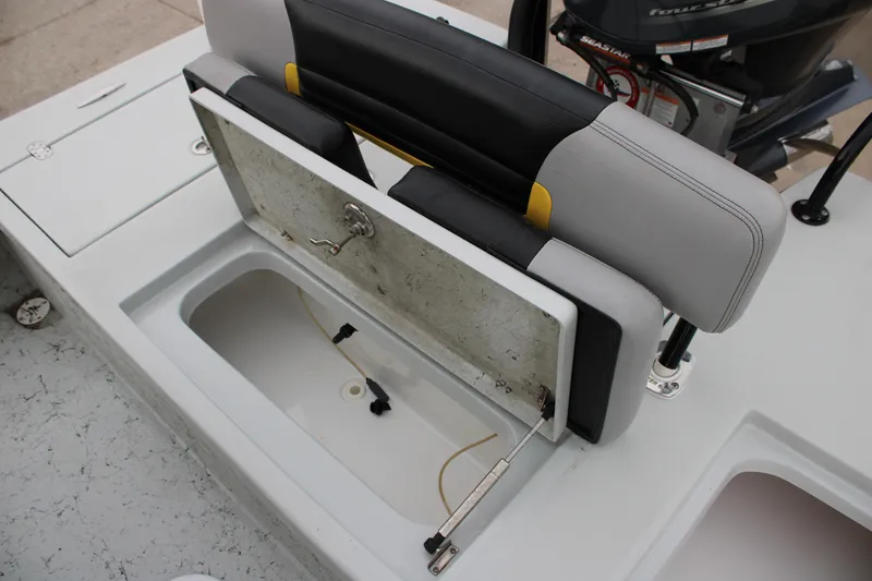 Slide: The Image of 2017 Blazer 2420 boat seat with storage compartment and engine in background. - 12