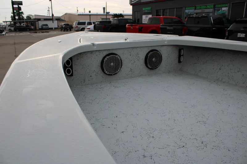 Slide: The Image of 2017 Blazer 2420 boat interior with speakers, parked in a lot. - 16