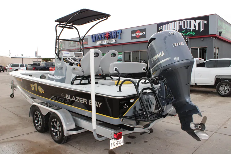 Slide: The Image of 2017 Blazer 2420 boat with Yamaha 300 engine at dealership. - 2