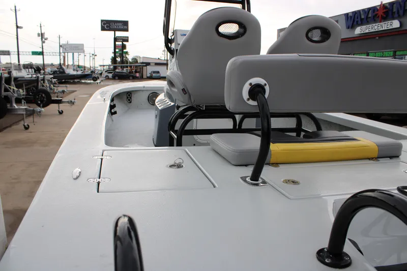 Slide: The Image of 2017 Blazer 2420 boat interior with seating and storage, parked at a dealership. - 3