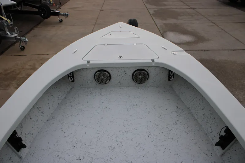 Slide: The Image of 2017 Blazer 2420 boat interior with storage compartments and speakers on a concrete surface. - 9