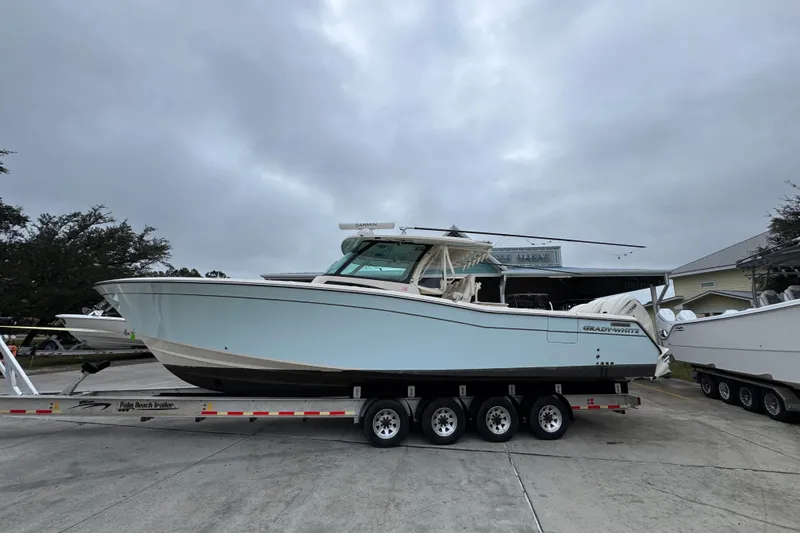 The Image of 2024 Grady-White Canyon 386 boat on trailer, overcast sky background. - 1