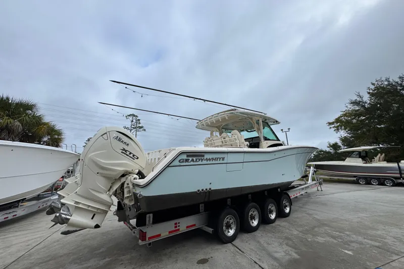 Slide: The Image of 2024 Grady-White Canyon 386 boat on trailer with Yamaha engines, parked outdoors. - 14
