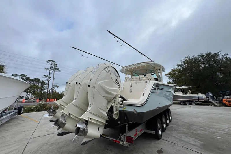 Slide: The Image of 2024 Grady-White Canyon 386 boat with triple outboard engines on a trailer. - 15