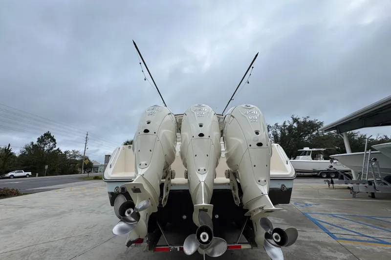 Slide: The Image of 2024 Grady-White Canyon 386 boat with triple 450 V8 engines, docked outdoors. - 17