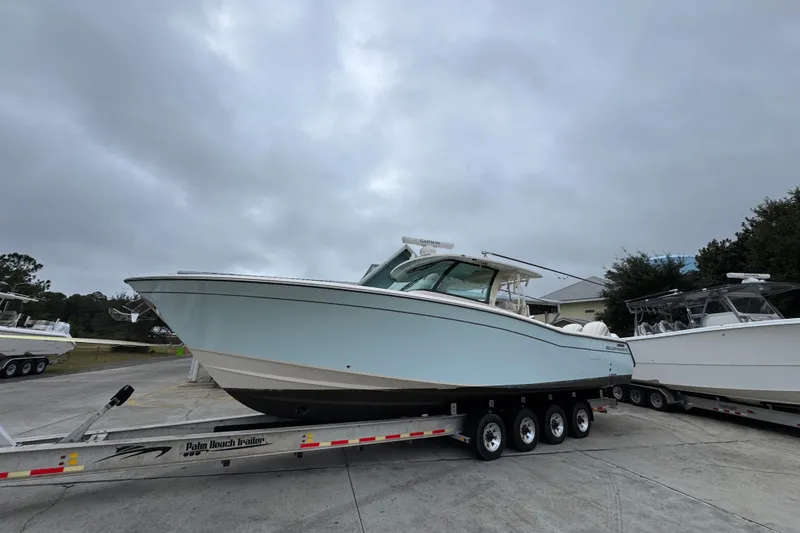 Slide: The Image of 2024 Grady-White Canyon 386 boat on trailer under cloudy sky. - 3