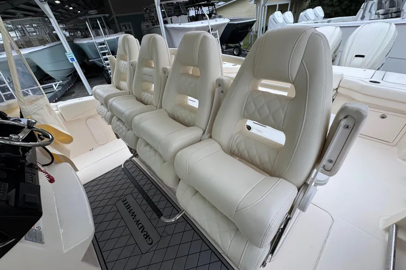 Slide: The Image of 2024 Grady-White Canyon 386 boat interior with luxurious white seating and helm. - 30