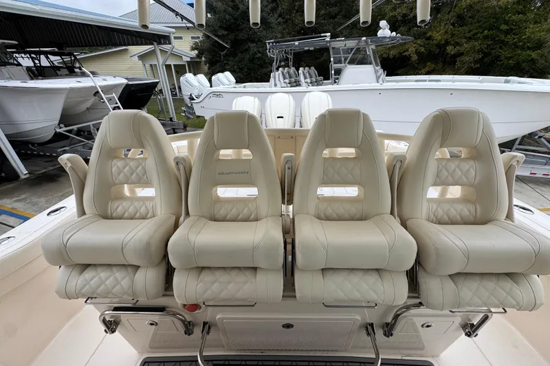 Slide: The Image of Luxurious seating on 2024 Grady-White Canyon 386 boat, featuring plush, cream-colored upholstery. - 31
