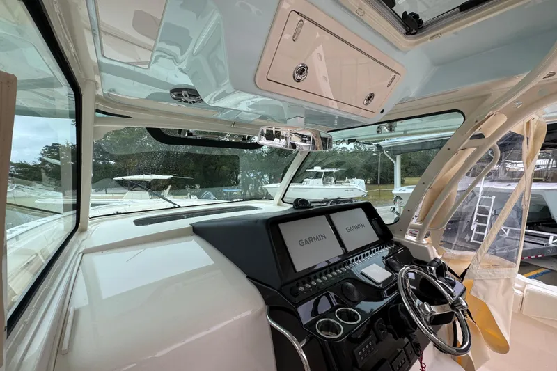 Slide: The Image of 2024 Grady-White Canyon 386 helm with Garmin displays and modern controls. - 34