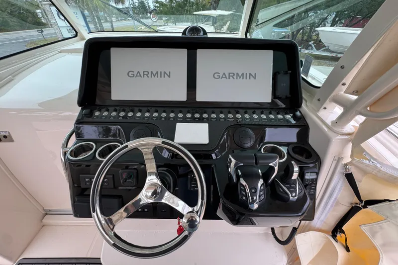 Slide: The Image of 2024 Grady-White Canyon 386 helm with dual Garmin displays and modern controls. - 35