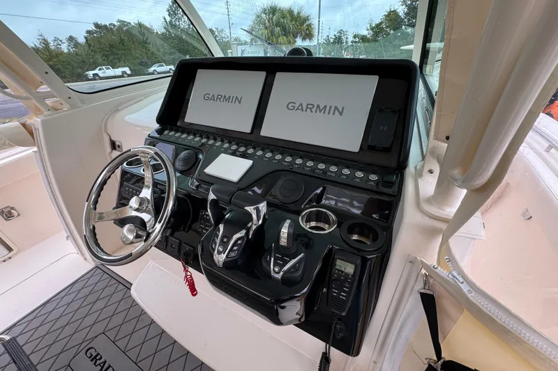 Slide: The Image of 2024 Grady-White Canyon 386 helm with dual Garmin displays and modern controls. - 38