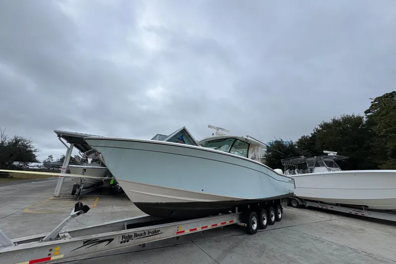 Slide: The Image of 2024 Grady-White Canyon 386 boat on trailer under cloudy sky. - 4