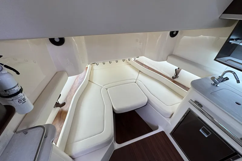 Slide: The Image of 2024 Grady-White Canyon 386 interior with seating, kitchenette, and fire extinguisher. - 44