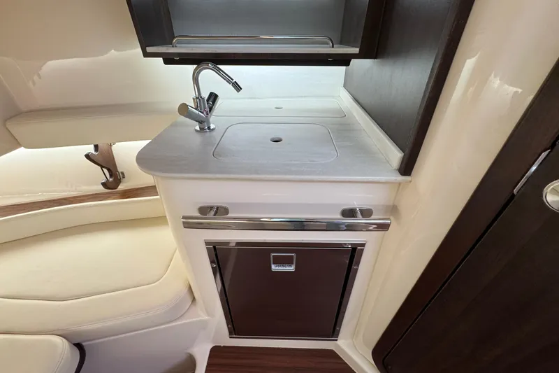 Slide: The Image of 2024 Grady-White Canyon 386 interior with compact kitchenette and modern sink design. - 45