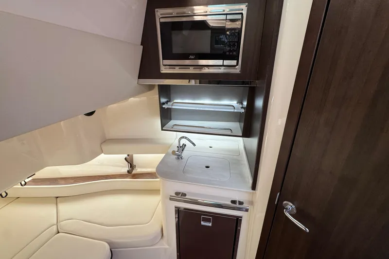 Slide: The Image of 2024 Grady-White Canyon 386 interior with kitchenette, featuring microwave and sink. - 46