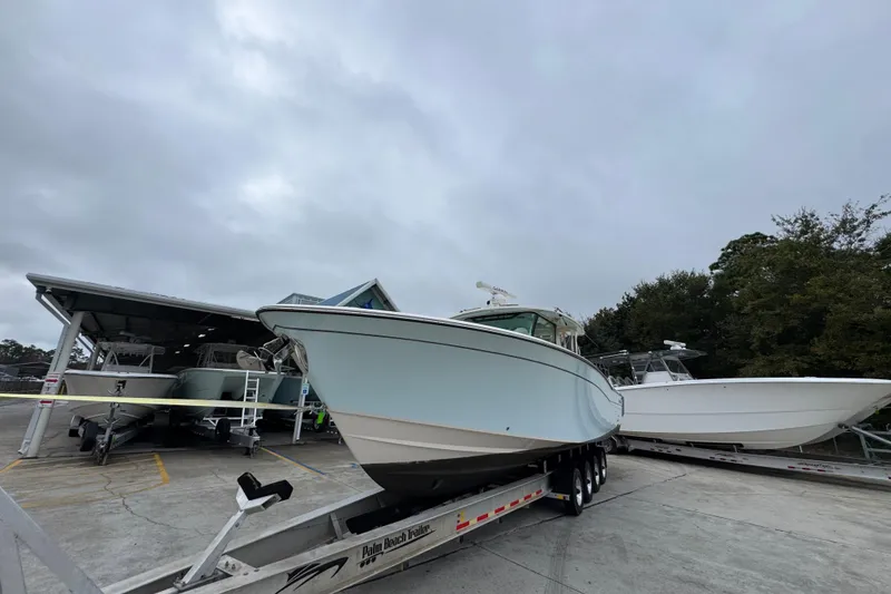 Slide: The Image of 2024 Grady-White Canyon 386 boat on trailer, overcast sky background. - 5