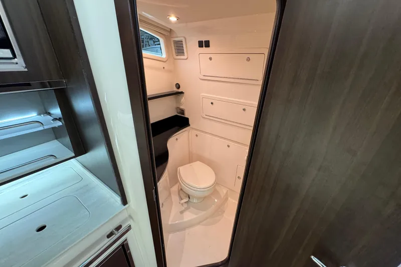 Slide: The Image of 2024 Grady-White Canyon 386 boat interior bathroom with modern fixtures and storage. - 50