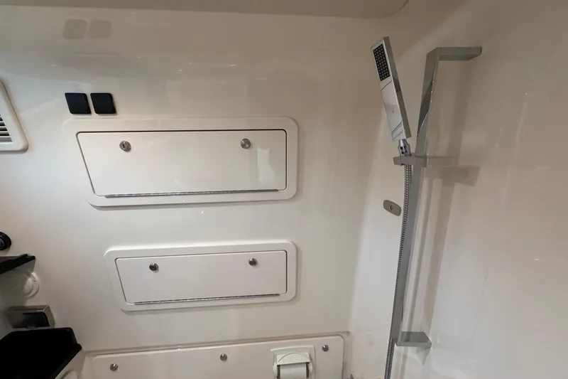 Slide: The Image of 2024 Grady-White Canyon 386 interior with sleek shower and storage compartments. - 52