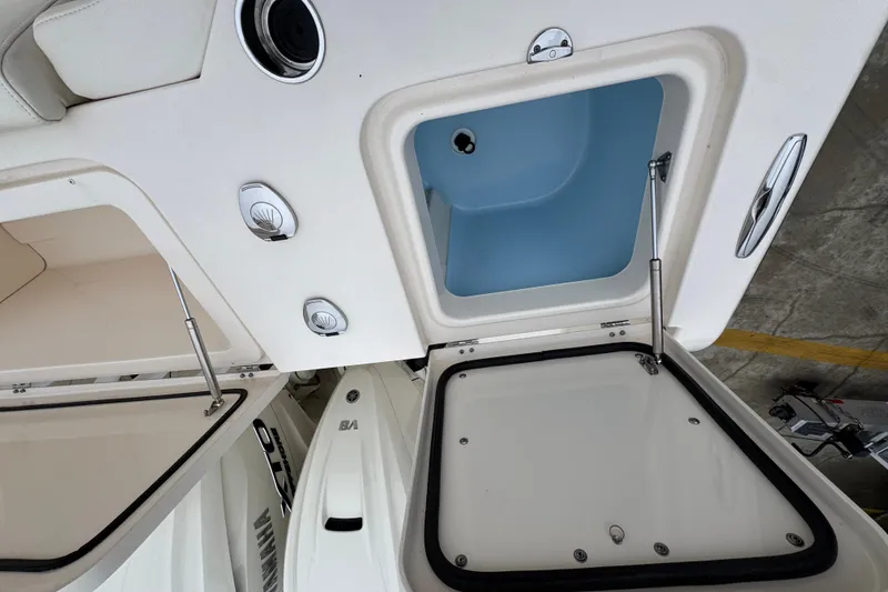 Slide: The Image of 2024 Grady-White Canyon 386 boat storage compartments with open hatches and hydraulic supports. - 62