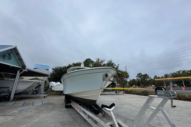Slide: The Image of 2024 Grady-White Canyon 386 boat on trailer in parking lot, overcast sky. - 8
