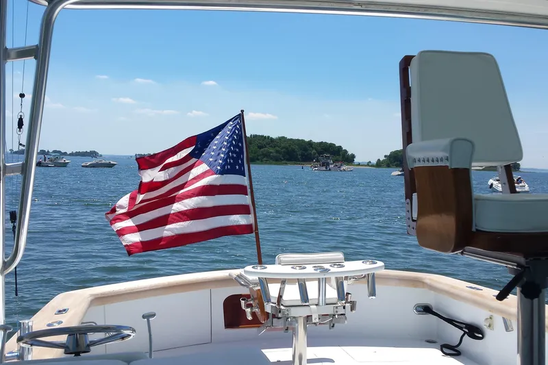 Slide: The Image of Sunny Briggs 37 Express boat, 1984, with American flag on a sunny day at sea. - 2
