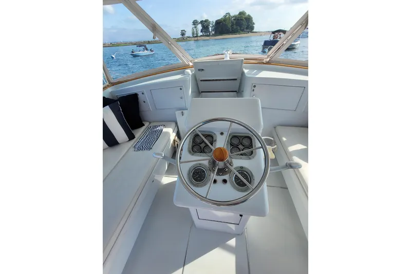 Slide: The Image of Helm of 1984 Sunny Briggs 37 Express boat with scenic water view. - 5