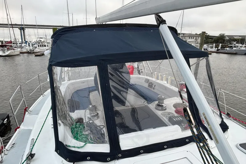 Slide: The Image of Hunter Passage 450 sailboat, 2000 model, docked with blue canopy and visible cockpit. - 10