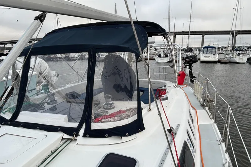 Slide: The Image of Sailboat Hunter Passage 450, 2000 model, docked in marina with protective canopy. - 11