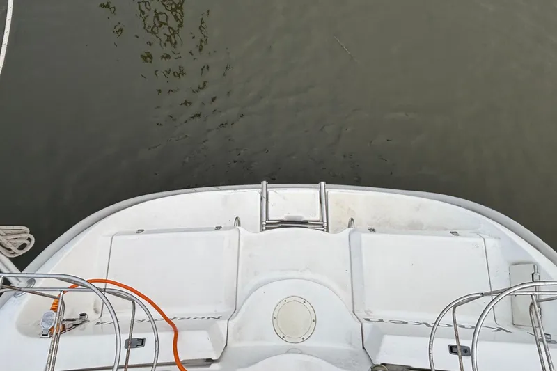 Slide: The Image of Hunter Passage 450 sailboat stern view, showing deck and water, year 2000 model. - 13