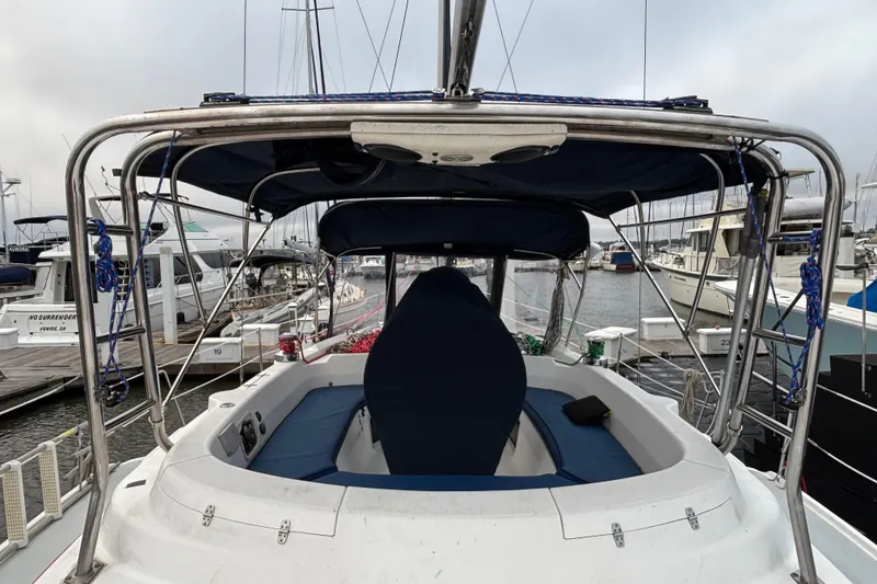 Slide: The Image of Hunter Passage 450 sailboat cockpit, 2000 model, docked at marina with surrounding boats. - 14