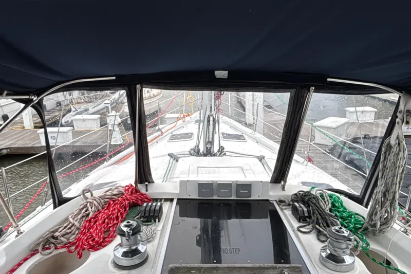 Slide: The Image of Cockpit view of 2000 Hunter Passage 450 sailboat with ropes and marina background. - 15