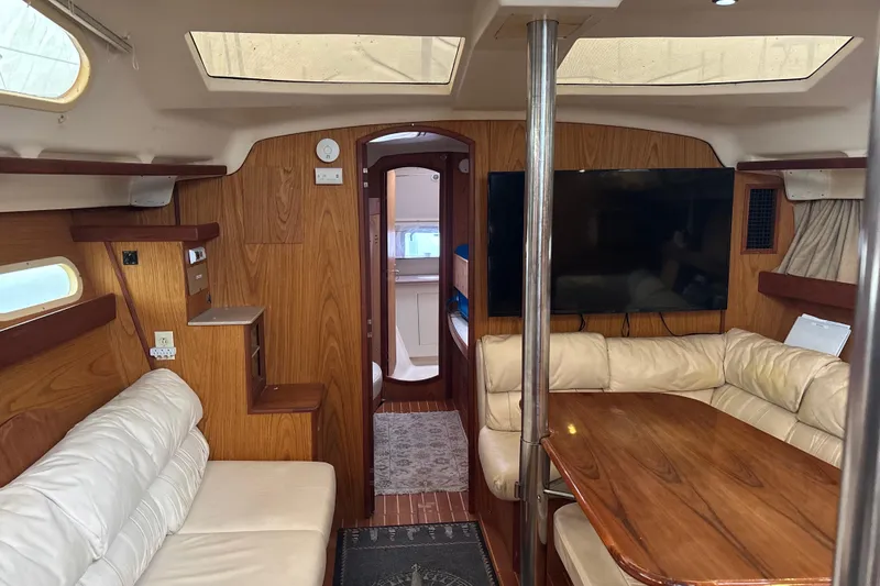 Slide: The Image of Interior of 2000 Hunter Passage 450 yacht with wood paneling and leather seating. - 17