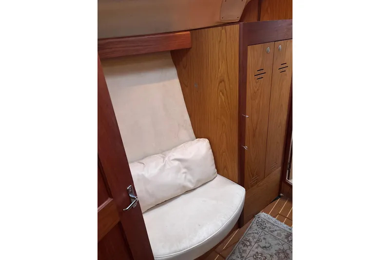 Slide: The Image of Interior of 2000 Hunter Passage 450 yacht with wooden paneling and cushioned seating. - 20