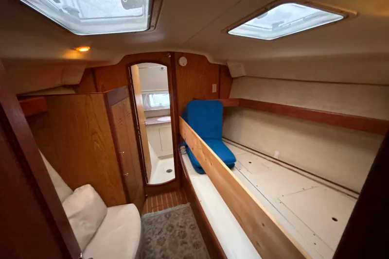 Slide: The Image of Interior of 2000 Hunter Passage 450 sailboat, featuring cozy cabin and wooden finishes. - 22