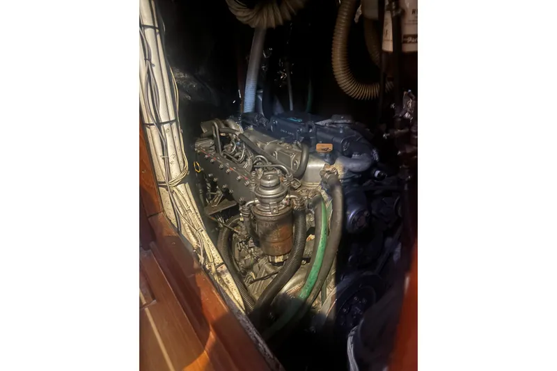 Slide: The Image of Engine compartment of a 2000 Hunter Passage 450 sailboat, showcasing mechanical components. - 28