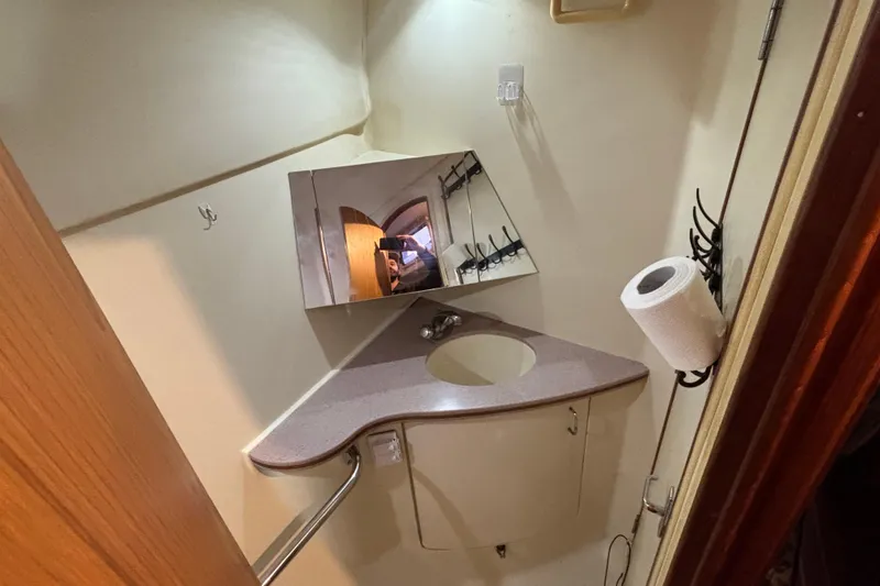 Slide: The Image of Small bathroom in 2000 Hunter Passage 450 yacht with sink, mirror, and toilet paper holder. - 29