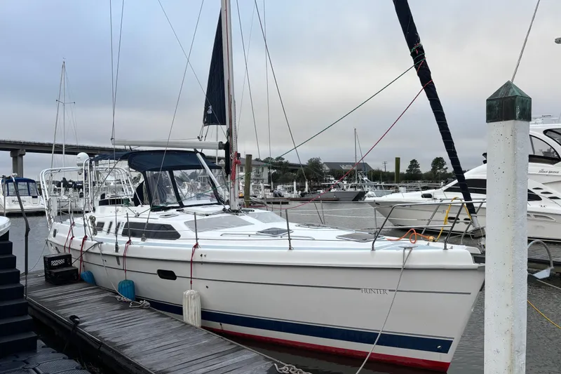 Slide: The Image of 2000 Hunter Passage 450 sailboat docked at marina, overcast sky, calm waters. - 3