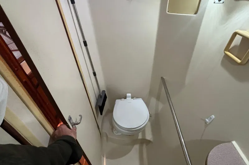 Slide: The Image of Interior of 2000 Hunter Passage 450 yacht bathroom with toilet and handrail. - 30