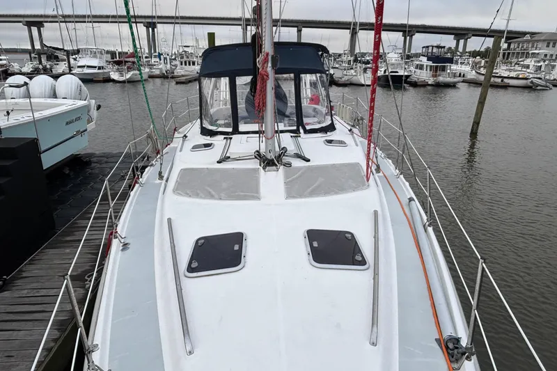 Slide: The Image of Hunter Passage 450 sailboat docked at marina, showcasing deck and cabin, year 2000 model. - 7